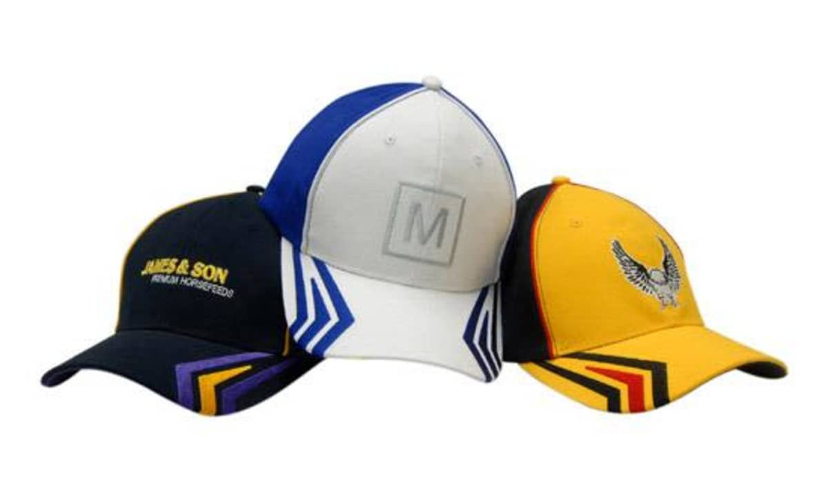 Three caps featuring various designs and colours: a navy cap, a grey and blue cap, and a yellow cap with embellishments.