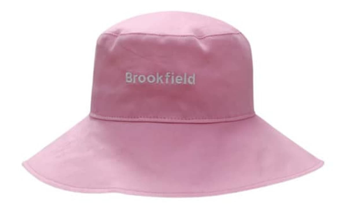 A pink cotton twill ladies hat with a wide brim and a logo on the front.