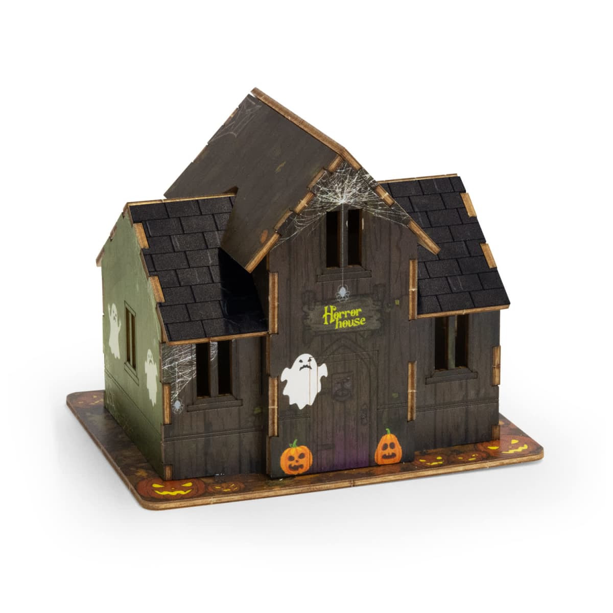 A wooden model of a spooky house in dark colours, featuring ghosts and pumpkins, with a logo on the front.