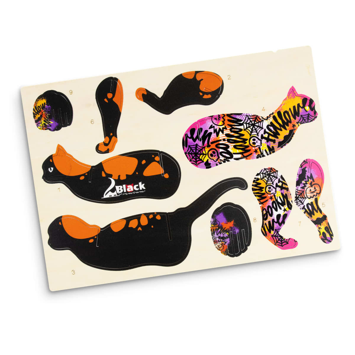 An assortment of cat-shaped wooden pieces in black and orange, featuring spooky designs in purple and pink.