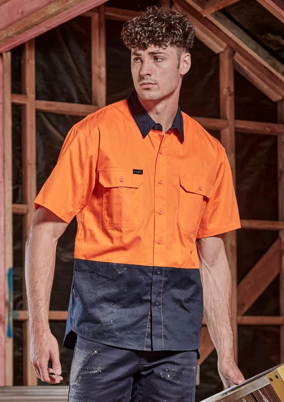 A short sleeve work shirt in bright orange and navy blue, featuring two chest pockets and a logo.