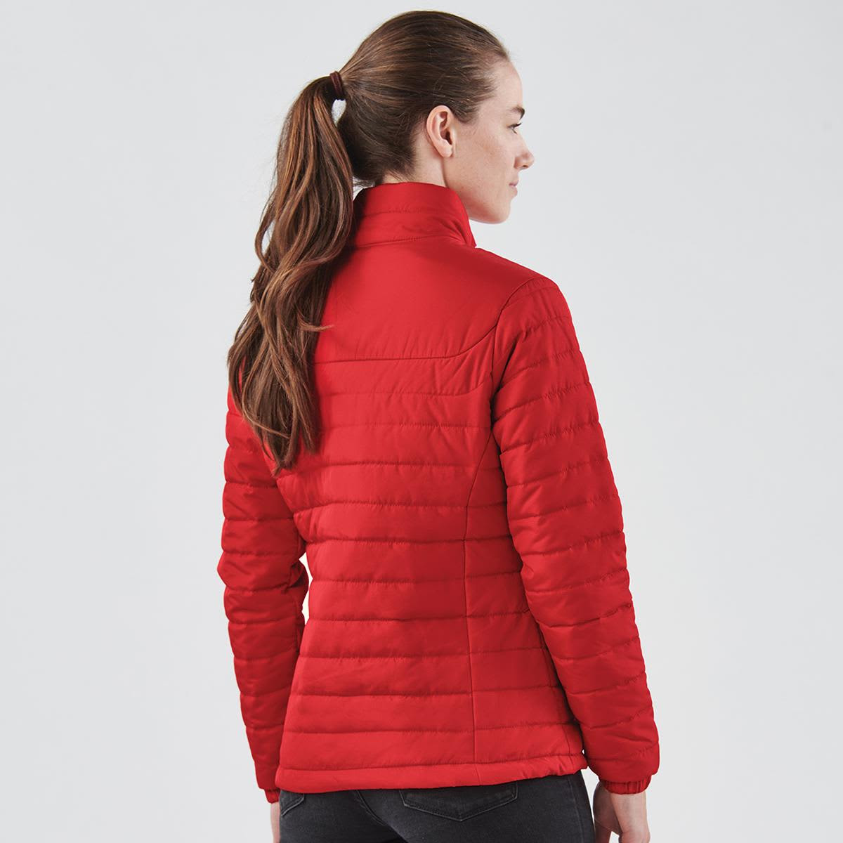 Red quilted jacket for women, featuring a high collar and a sleek design. Includes a branding logo.