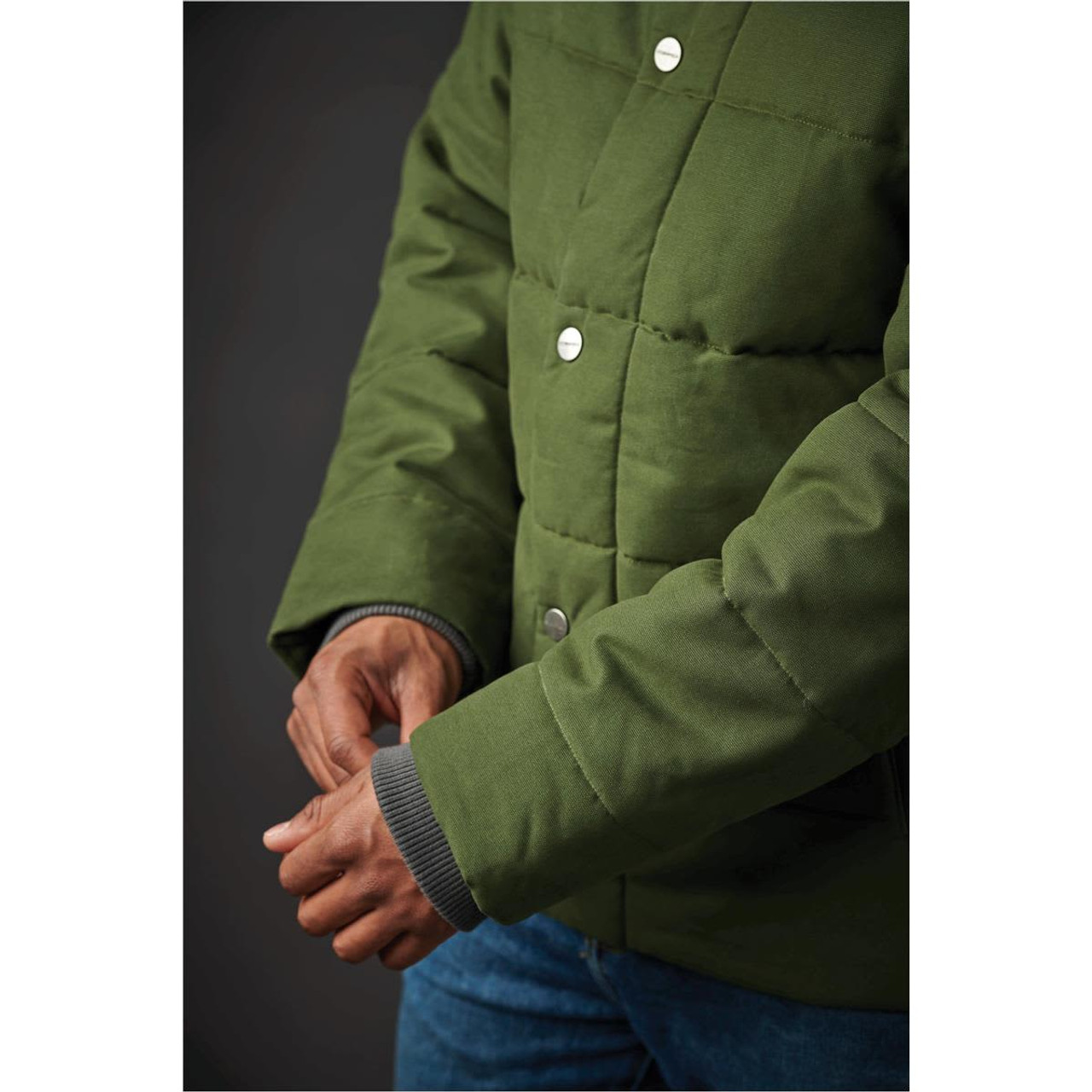 A green thermal jacket with a quilted design and silver snaps, featuring a textured cuff.