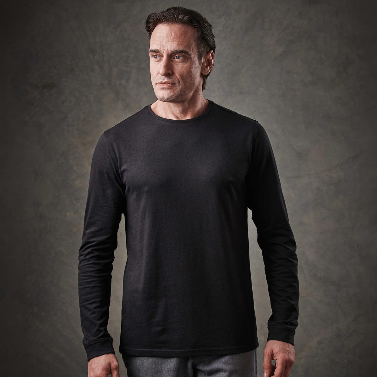 A black long-sleeve T-shirt displayed on a model, featuring a fitted design and a round neckline.