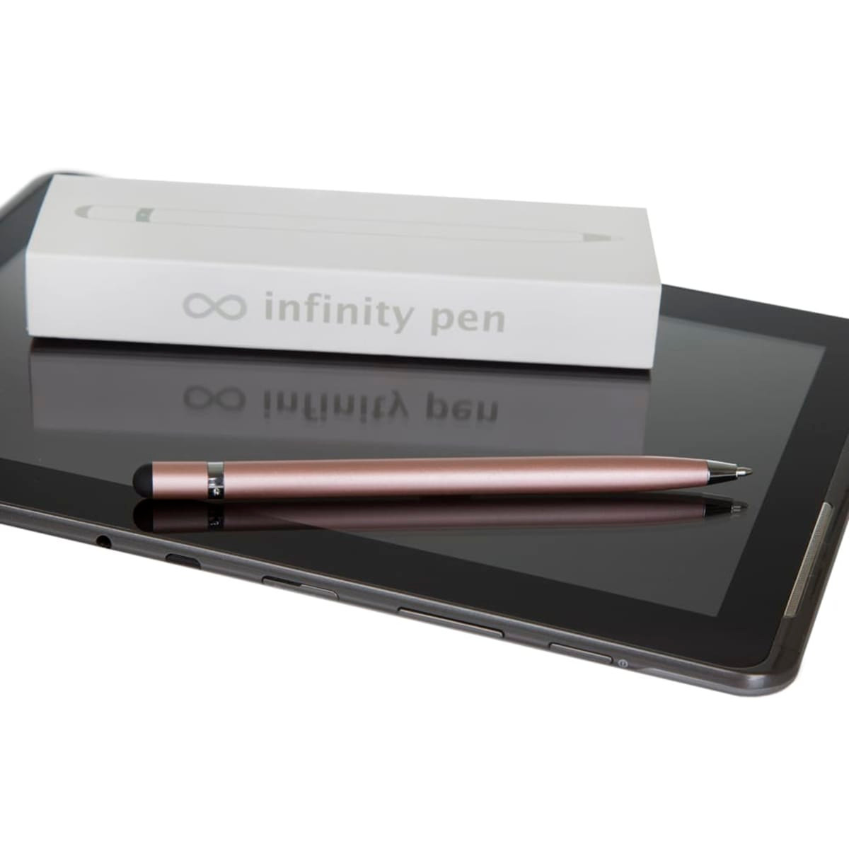 A metal Infinity Pen in rose gold rests beside a tablet and its packaging on a glossy surface.