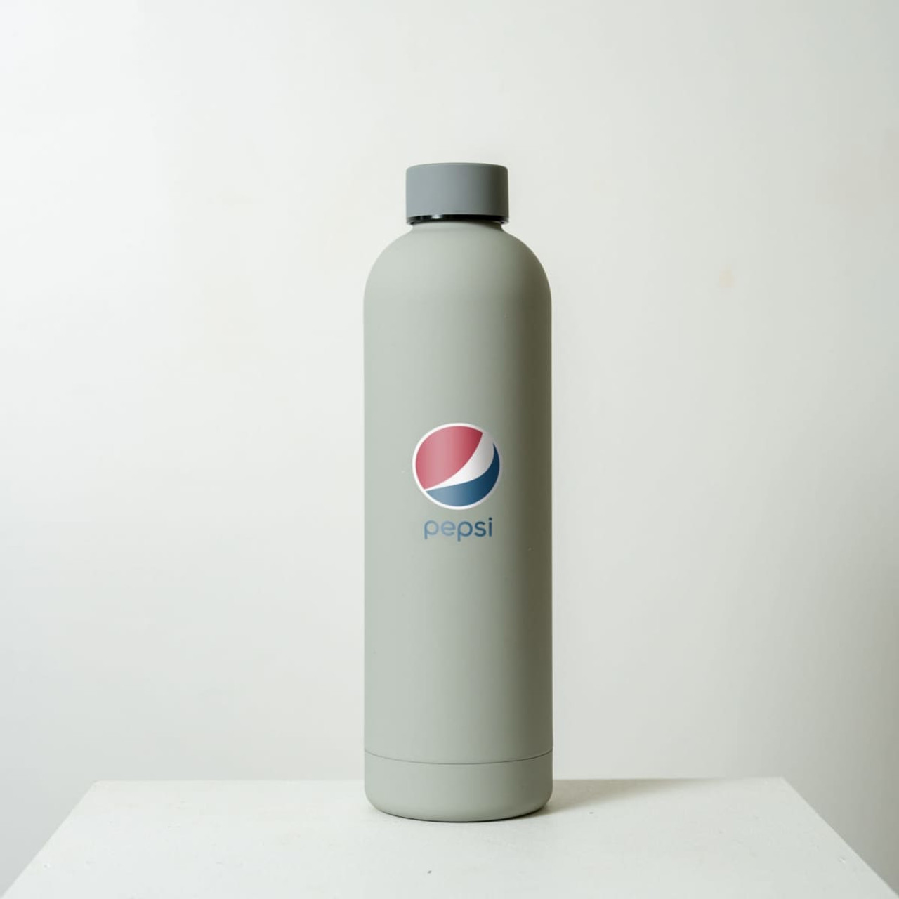 A drink bottle in grey, featuring a logo. The bottle has a sleek design with a wide mouth.