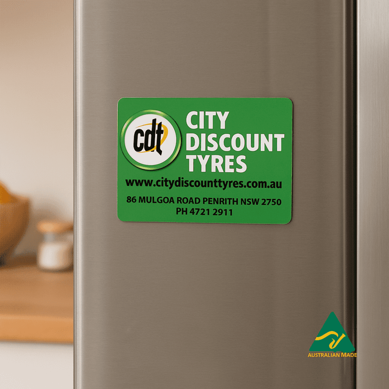 A green fridge magnet with rounded corners featuring a logo and text for City Discount Tyres.