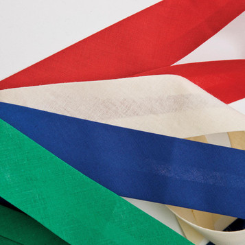 A collection of ribbon strips in red, white, blue, green, and cream laid out on a white background.