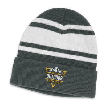 A green and white striped beanie with a folded cuff and a logo on the front.