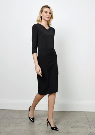 A black below-knee skirt paired with a three-quarter sleeve top, modelled by a woman in high heels. A black below-knee skirt paired with a three-quarter sleeve top, modelled by a woman in high heels.