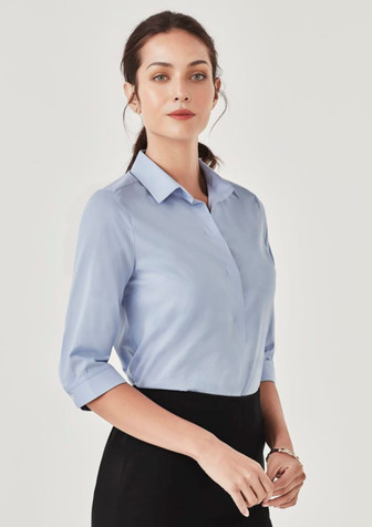 A light blue women's button-up shirt with three-quarter sleeves and a collar, featuring a subtle branding logo. A light blue women's button-up shirt with three-quarter sleeves and a collar, featuring a subtle branding logo.