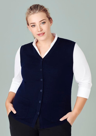 A navy blue women's button front knit vest featuring a v-neck and front pockets, paired with a white shirt. A navy blue women's button front knit vest featuring a v-neck and front pockets, paired with a white shirt.