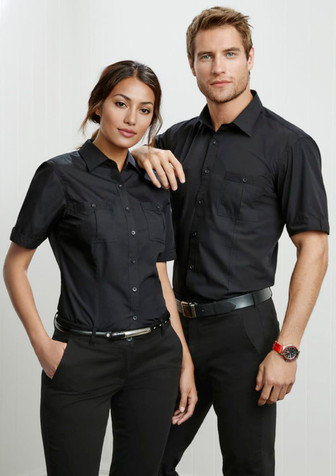 A black short sleeve button-up shirt with two chest pockets and a logo. Worn by a male and female model. A black short sleeve button-up shirt with two chest pockets and a logo. Worn by a male and female model.