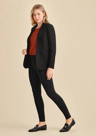 A model wearing black high-rise pull-on corporate leggings with a fitted blazer and a rust top, styled with loafers.