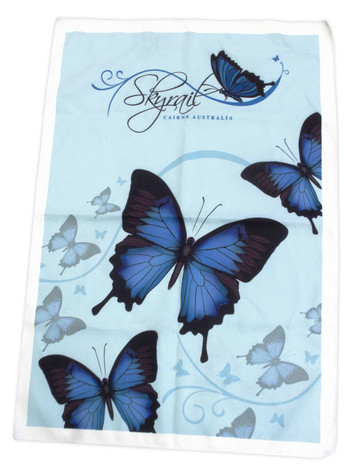 A blue microfiber tea towel featuring butterfly designs on a light blue background. Includes branding.