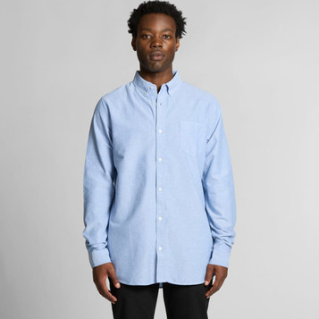 A light blue button-up shirt with a chest pocket and a collar, featuring a small logo on the chest. A light blue button-up shirt with a chest pocket and a collar, featuring a small logo on the chest.