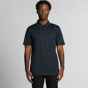 A black polo shirt featuring a collar and a logo, displayed on a model against a plain background.