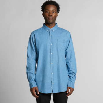 A blue denim button-up shirt with a chest pocket and a logo, featuring long sleeves and a collared neck. A blue denim button-up shirt with a chest pocket and a logo, featuring long sleeves and a collared neck.