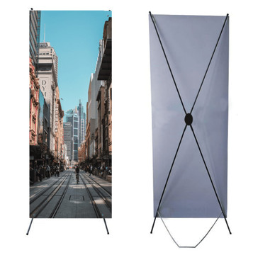 An X banner featuring a city street scene, set against a light blue background with a sturdy black frame. An X banner featuring a city street scene, set against a light blue background with a sturdy black frame.