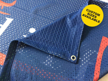 A mesh polyester banner with a blue background and perforated design, featuring a corner grommet and branding.