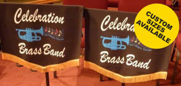 Two black music stand covers with decorative fringes, featuring blue trumpet illustrations and a logo.