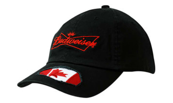 A black cap featuring a frayed applique of the Canadian flag on the peak and a logo on the front.