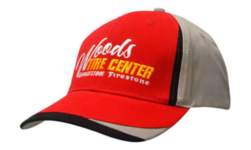 A red and grey cap featuring fabric inserts on the crown and peak, with a logo on the front.