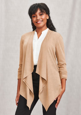 A woman wearing a beige waterfall cardigan over a white blouse and black trousers, smiling at the camera. A woman wearing a beige waterfall cardigan over a white blouse and black trousers, smiling at the camera.