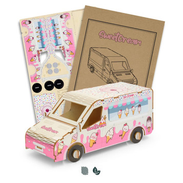 A wooden model of an ice cream van in pink and white, alongside assembly instructions and decorative stickers.