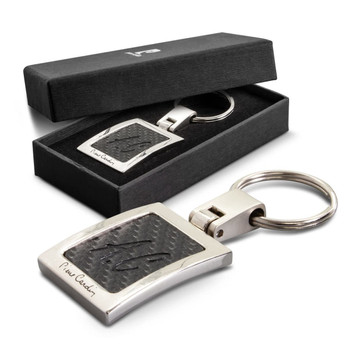 A silver key ring featuring a textured black design, presented in a black gift box. A silver key ring featuring a textured black design, presented in a black gift box.