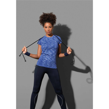 A woman demonstrates a blue active seamless raglan t-shirt paired with black leggings, holding exercise ropes. A woman demonstrates a blue active seamless raglan t-shirt paired with black leggings, holding exercise ropes.