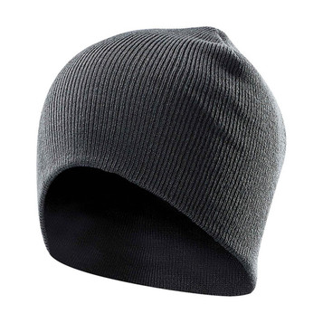 A grey knit beanie with a snug fit and a simple design, featuring a logo on one side. A grey knit beanie with a snug fit and a simple design, featuring a logo on one side.