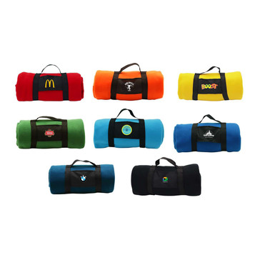A collection of rolled-up blankets in various colours including red, orange, green, blue, and yellow, featuring different logos. A collection of rolled-up blankets in various colours including red, orange, green, blue, and yellow, featuring different logos.