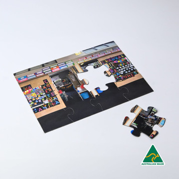 A5 Magnetic Jigsaw featuring a vibrant image of a shop with various products displayed. Includes a loose puzzle piece. A5 Magnetic Jigsaw featuring a vibrant image of a shop with various products displayed. Includes a loose puzzle piece.