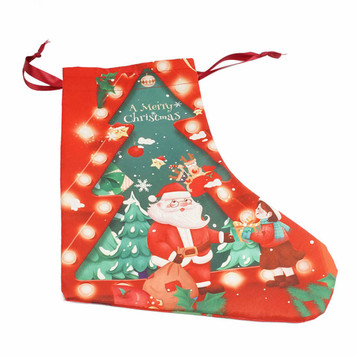 A red Christmas stocking featuring Santa surrounded by festive decorations and a tree design. Includes a decorative drawstring. A red Christmas stocking featuring Santa surrounded by festive decorations and a tree design. Includes a decorative drawstring.