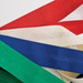 A collection of ribbon strips in red, white, blue, green, and cream laid out on a white background.