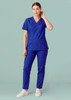 Unisex Hartwell reversible scrub pant in vibrant blue, featuring a relaxed fit and pockets, modelled by a woman.
