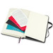 An opened Moleskine 2026 Daily Planner with blank pages, featuring colourful stickers and a black ribbon bookmark.