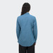 A women's denim shirt in light blue with long sleeves and a button-up design, featuring a logo on the back.