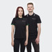 A black polo shirt featuring contrasting green and white collar details, worn by two models. The shirt has a logo.