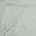 A close-up of a light green fabric featuring a seamless pocket, part of a hoodie design.