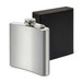 A silver hip flask with a screw top, displayed alongside a black box. It features a logo on the flask. A silver hip flask with a screw top, displayed alongside a black box. It features a logo on the flask.