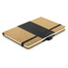 A cork notebook with a black elastic band, featuring a softcover and a contrasting interior. It has a logo on the cover.