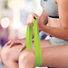 Green resistance exercise band held by a person sitting, with a blurred background. Green resistance exercise band held by a person sitting, with a blurred background.