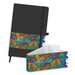A black notebook with an elastic band, featuring a colourful leaf-patterned sleeve and a matching envelope.