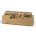 A bamboo desk calendar featuring wooden blocks for day, date, and month. The blocks are arranged on a rectangular base. A bamboo desk calendar featuring wooden blocks for day, date, and month. The blocks are arranged on a rectangular base.