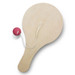 A wooden paddle ball game with a round paddle and a red ball attached by a white string. A wooden paddle ball game with a round paddle and a red ball attached by a white string.