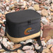 A black cooler bag with a textured base and a branding logo, placed on a bed of pebbles.