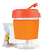 A reusable coffee cup with an orange lid and silicone sleeve, accompanied by a pack of jelly beans. A reusable coffee cup with an orange lid and silicone sleeve, accompanied by a pack of jelly beans.