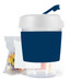 A reusable coffee cup with a dark blue sleeve and a white lid, accompanied by a pack of colorful jelly beans. A reusable coffee cup with a dark blue sleeve and a white lid, accompanied by a pack of colorful jelly beans.